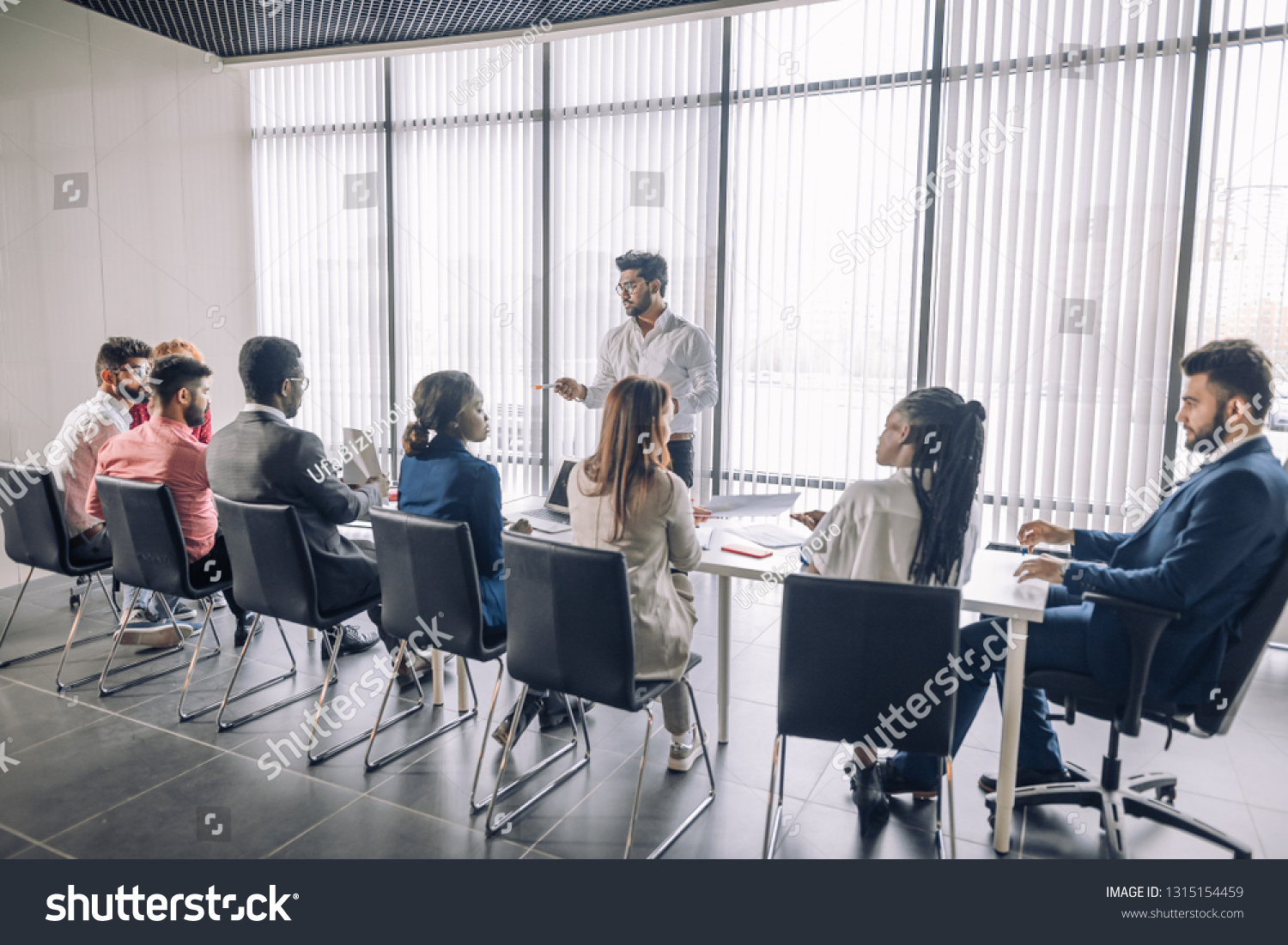 stock-photo-backside-of-group-of-diverse-multiracial-applicants-for-a-vacant-post-or-corporate-job-sitting-in-a-1315154459
